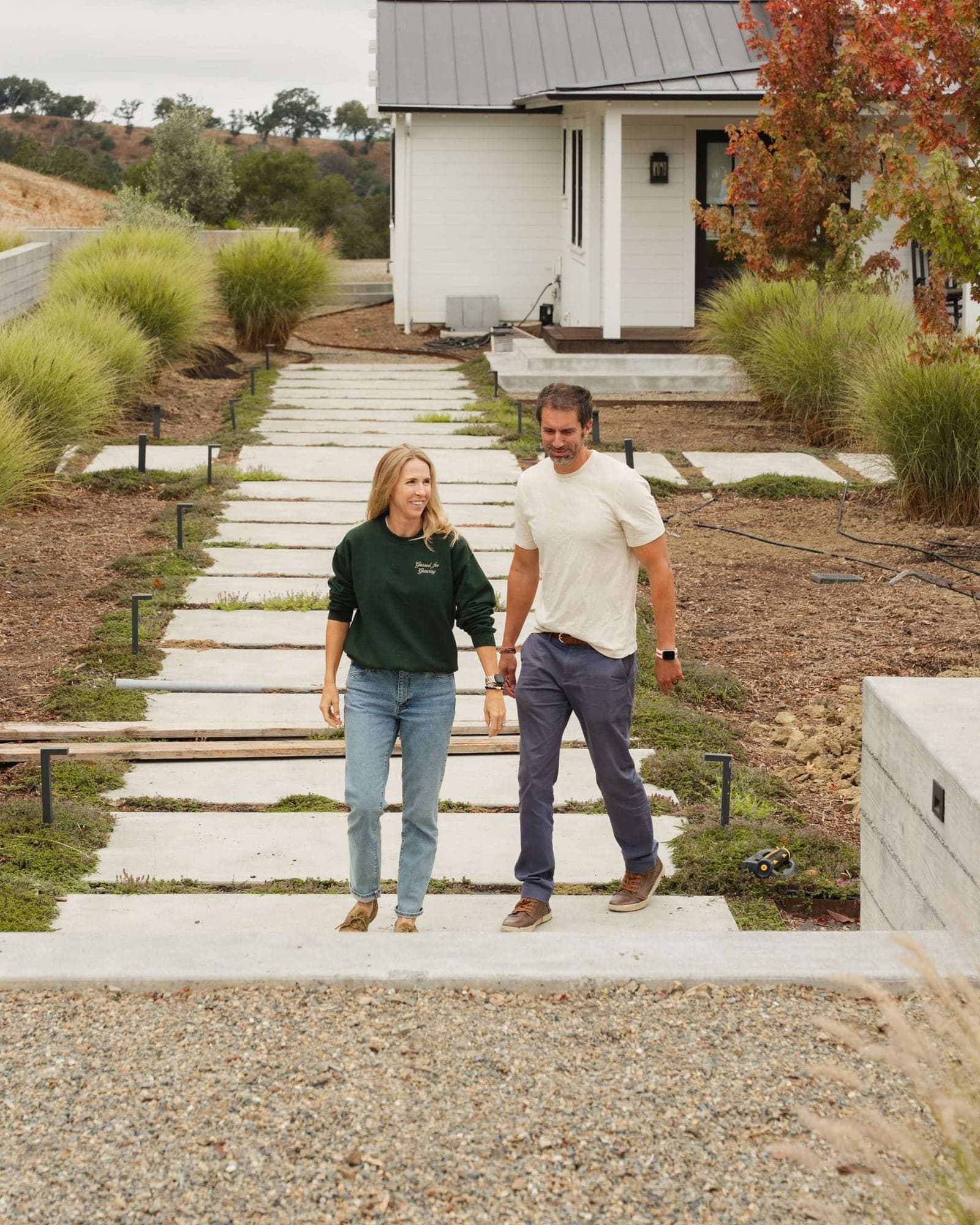 Megan and Lee Mokri walking together through a completed landscape